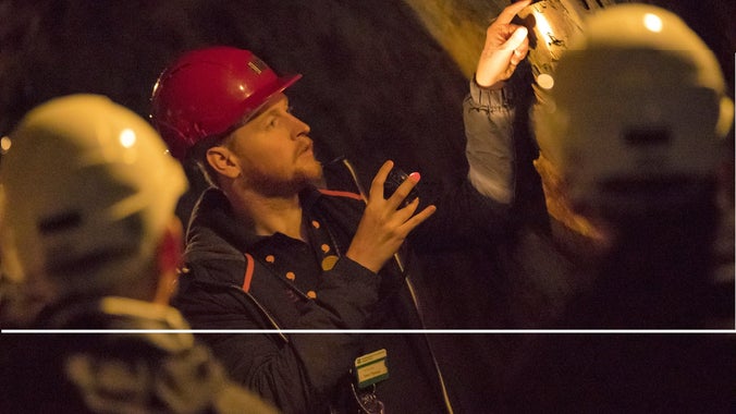 Tour guide with visitors at Dolaucothi Gold Mines, Carmarthenshire